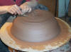 Trimming the leather hard pot.
